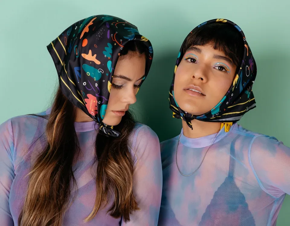 Two models wearing printed FRIKI headscarves