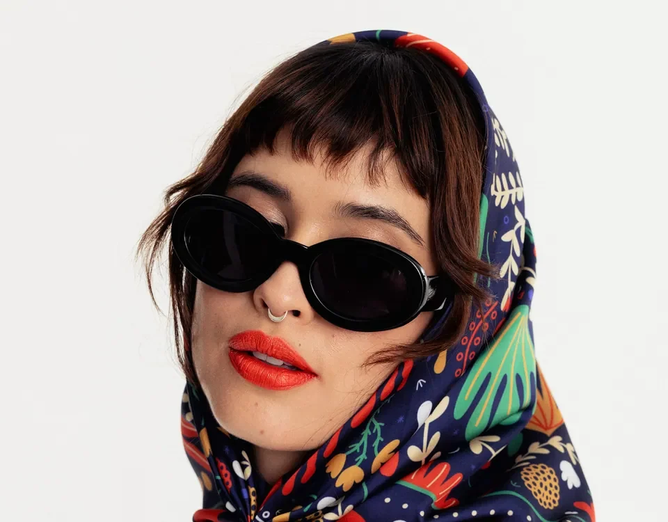 Model in sunglasses wearing a printed Kathiuska headscarf